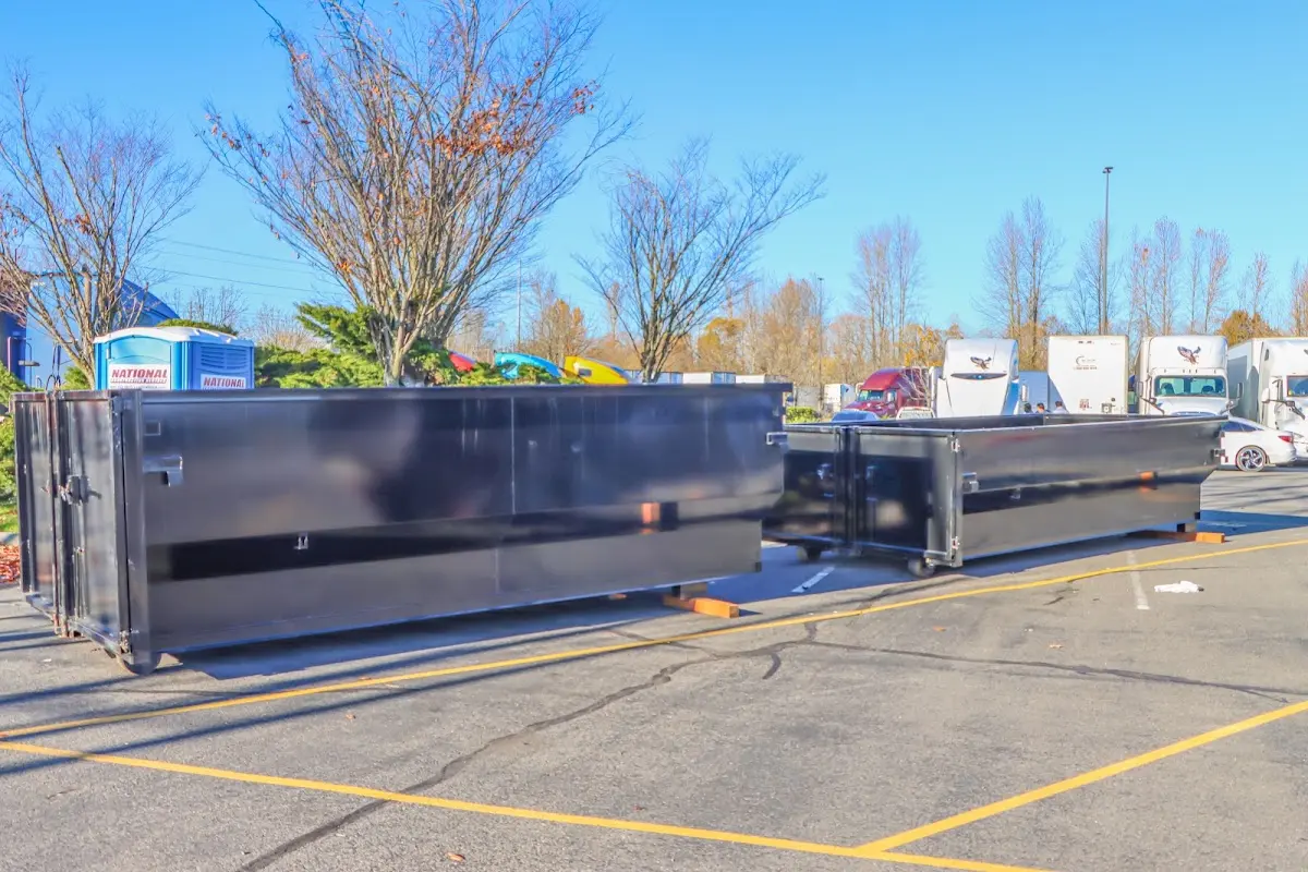 Professional dumpster rental service with roll-off container on residential driveway in Chili